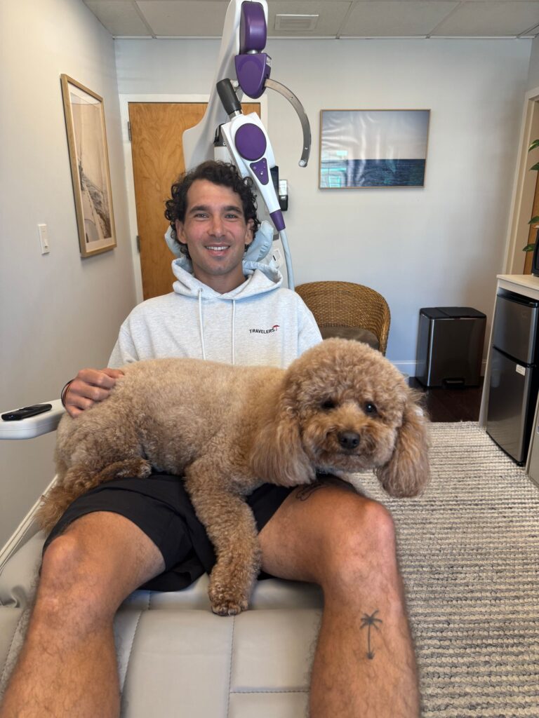 TMS Greenwich patient with therapy dog during NeuroStar session